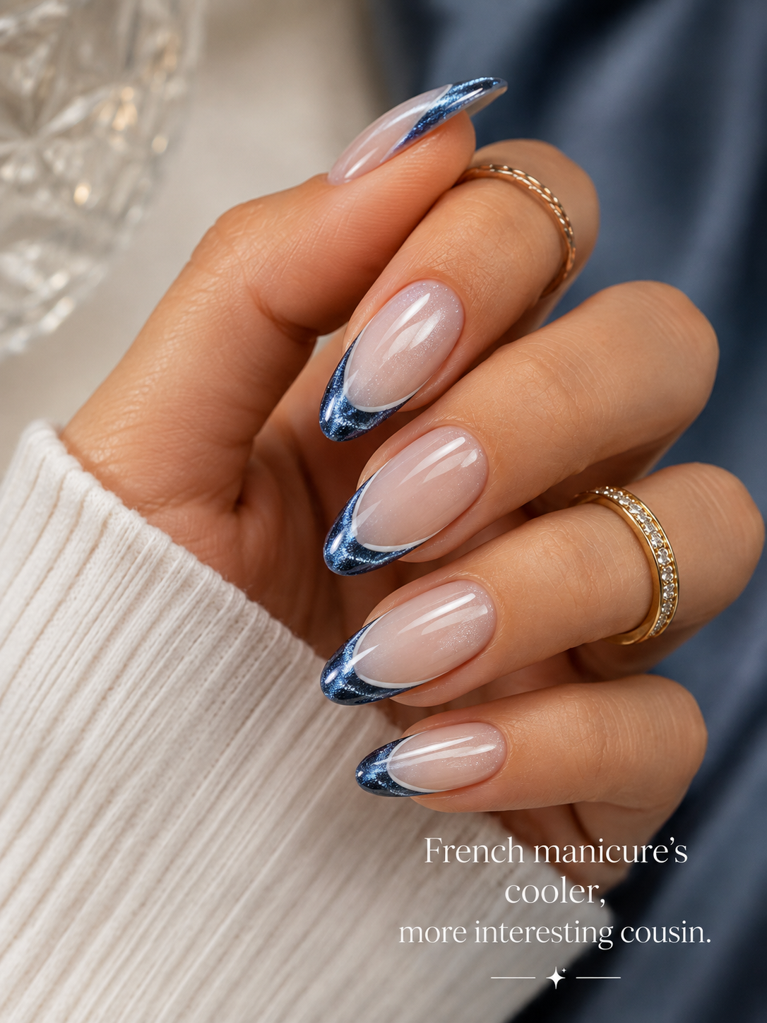 Blue cat eye French manicure with shimmering magnetic tips on glossy almond-shaped nude nails